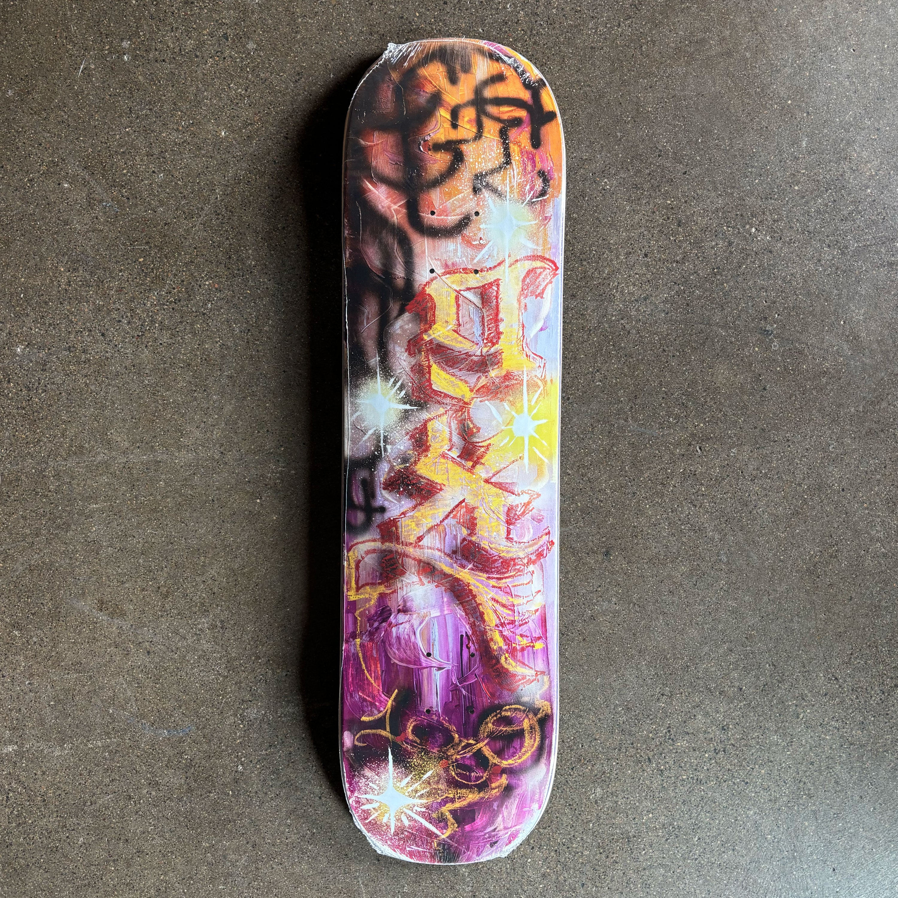 Full image of deck. Graffiti style artwork throughout.